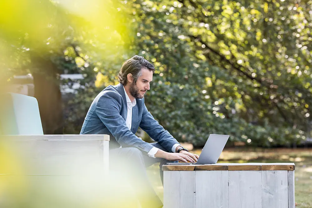 Employee working from home in the garden.