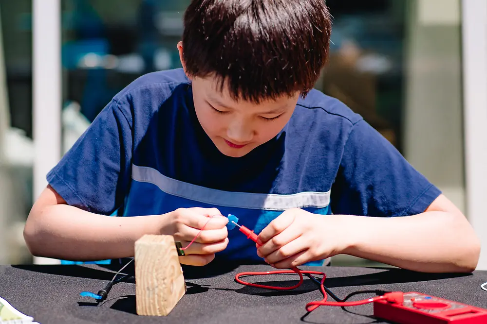 child conducting experiments at Henkel Researchers’ World