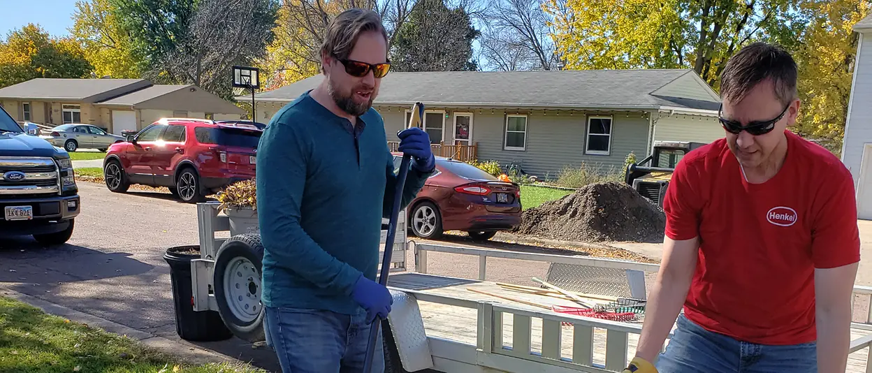 Men moving garbage cans