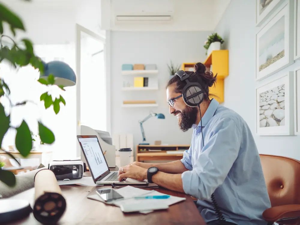 Man with headset sitting at desk working 