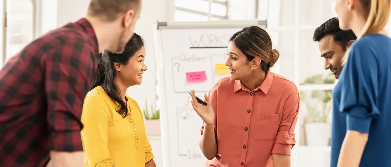 Employees brainstorming together in front of a flipchart