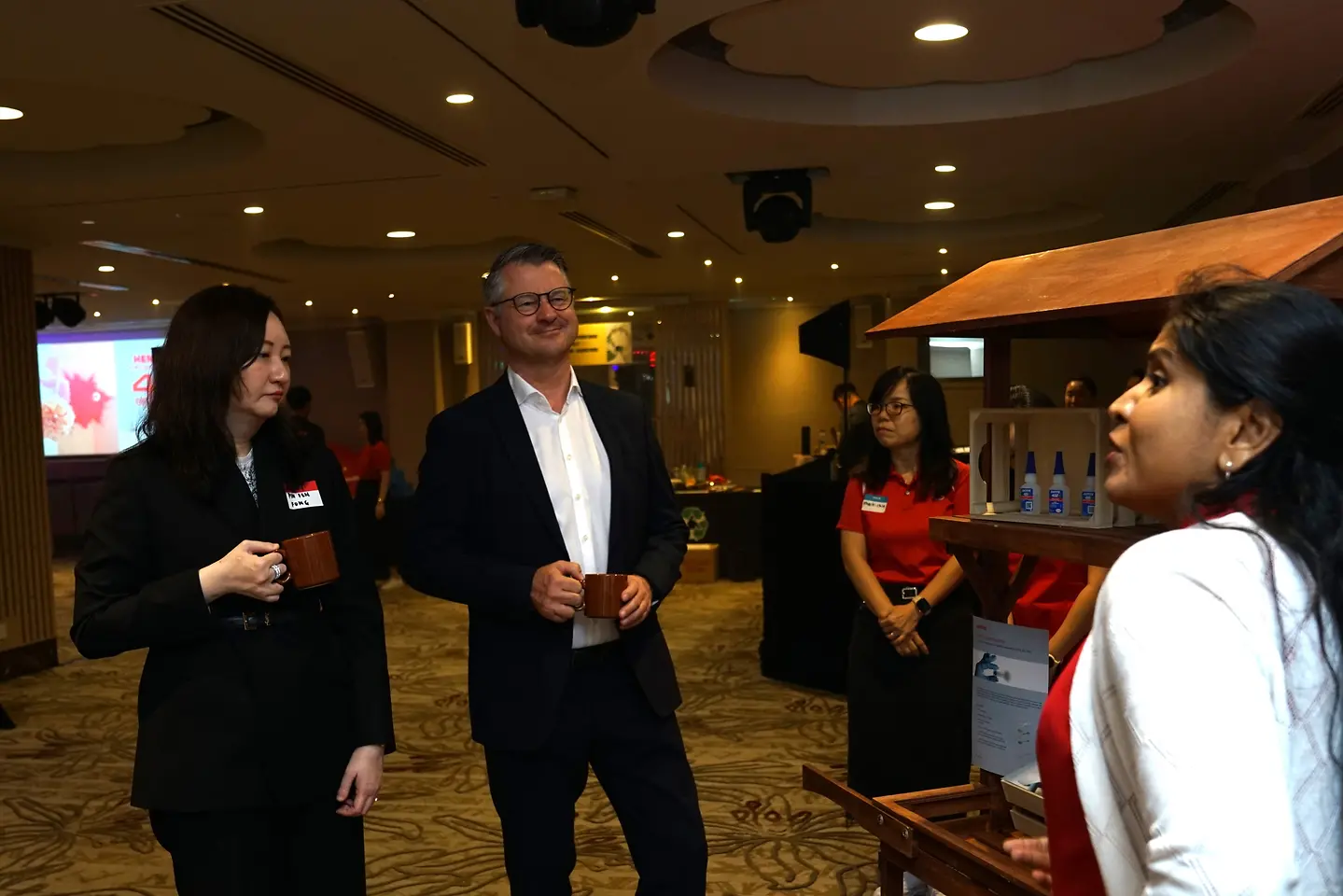 Two people walking along event booths