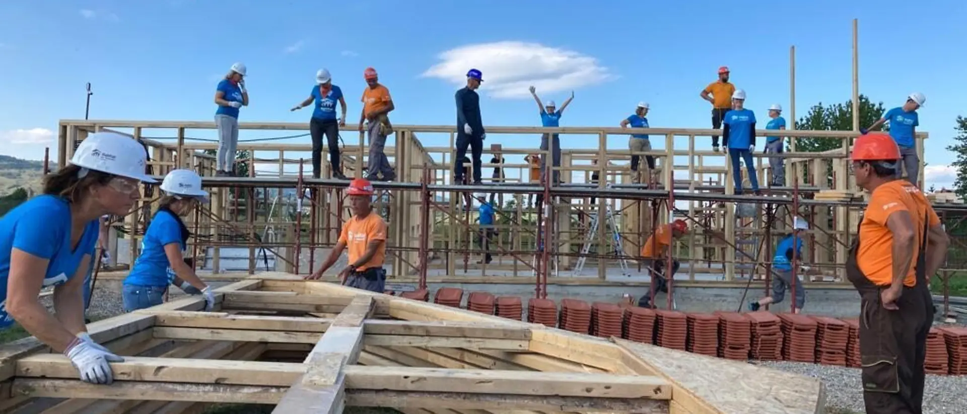 Many volunteers work on a construction site.