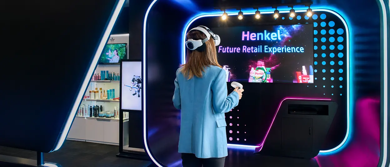 A woman can be seen from behind using a VR application from Henkel.