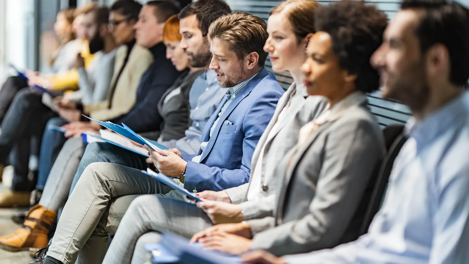 People in office attire seated in a row.