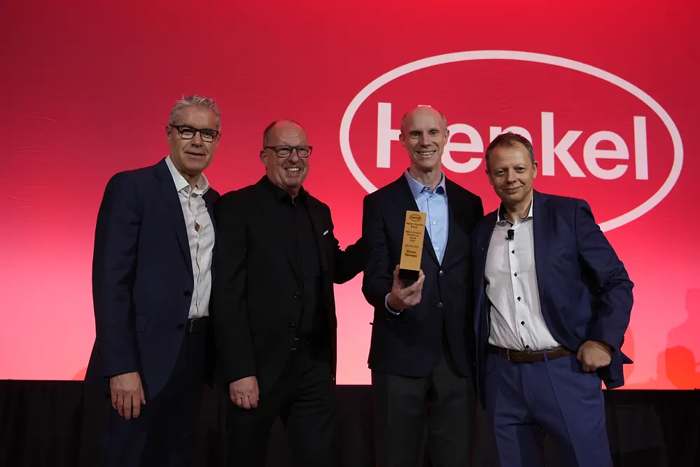 People posing with award 