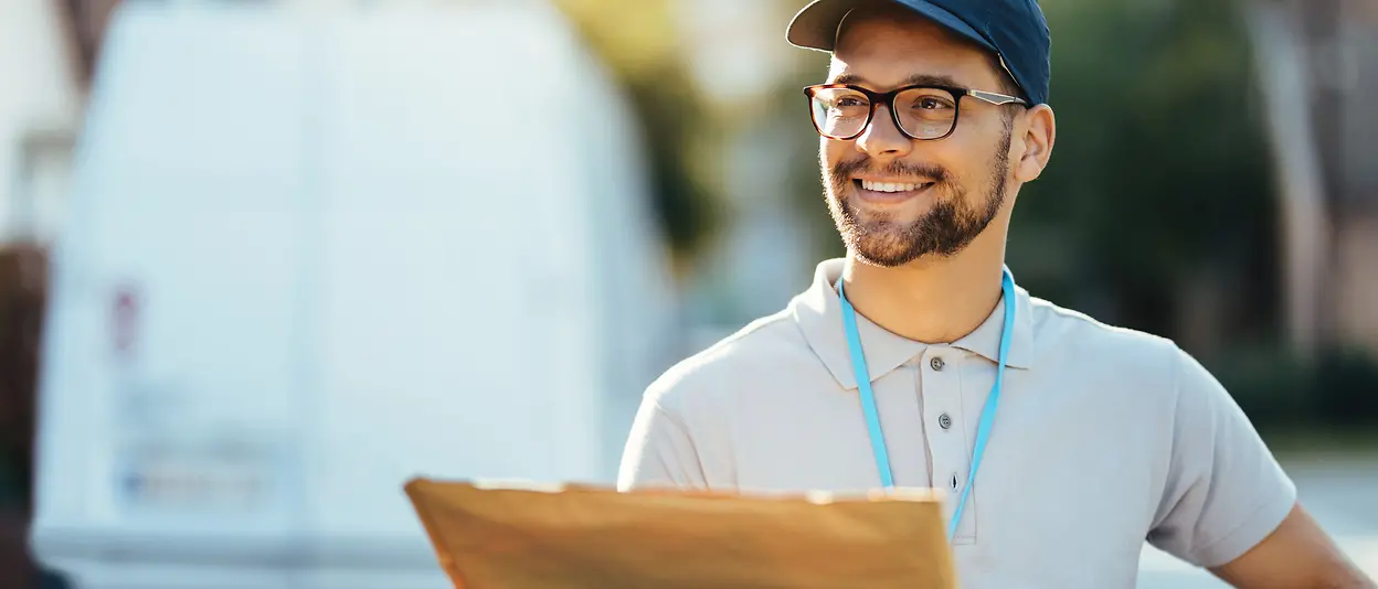 A deliver man is holding a shipping envelope in his hand that uses the EPIX technology