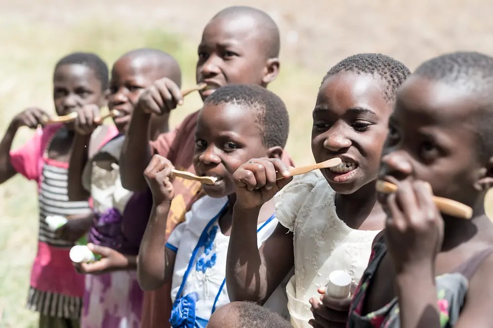 Children and their caregivers learn the right techniques for brushing their teeth