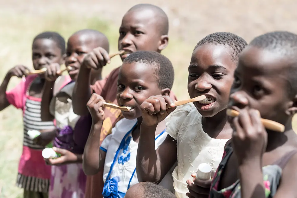 Children and their caregivers learn the right techniques for brushing their teeth