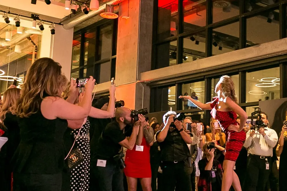 A hair model greets the crowd at the end of the runway at the opening of Henkel’s #AcademyofHair on June 14, 2018.