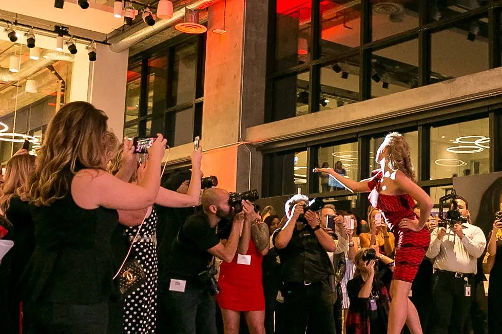 A hair model greets the crowd at the end of the runway at the opening of Henkel’s #AcademyofHair on June 14, 2018.